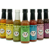 Row of Fat Cat hot sauce bottles with colorful labels on a white background